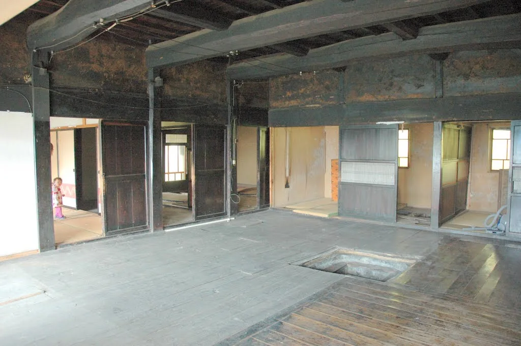 Interior of the Hakuba kominka before restoration with original timber beams and old floor