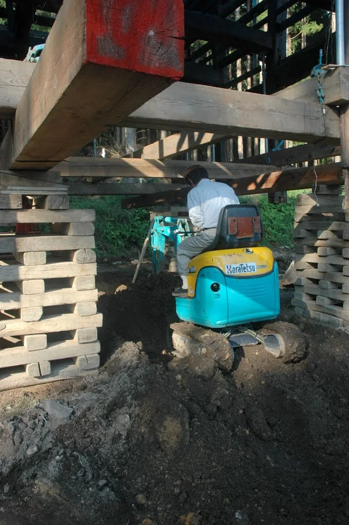 Close view of structural work beneath a timber post during the kominka renovation