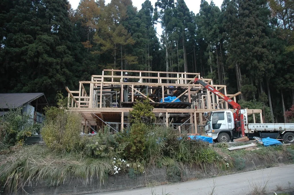 New timber framing taking shape around the original Hakuba kominka structure during renovation