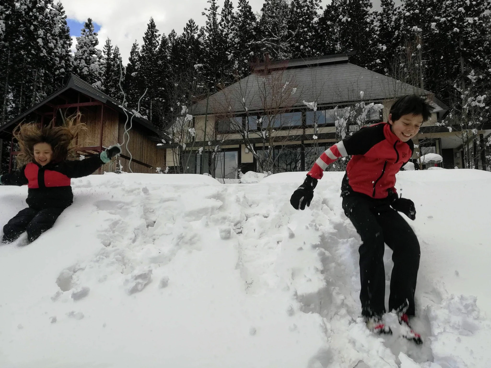 Children playing in deep snow outside Rental Farmhouse Tamaki in Hakuba