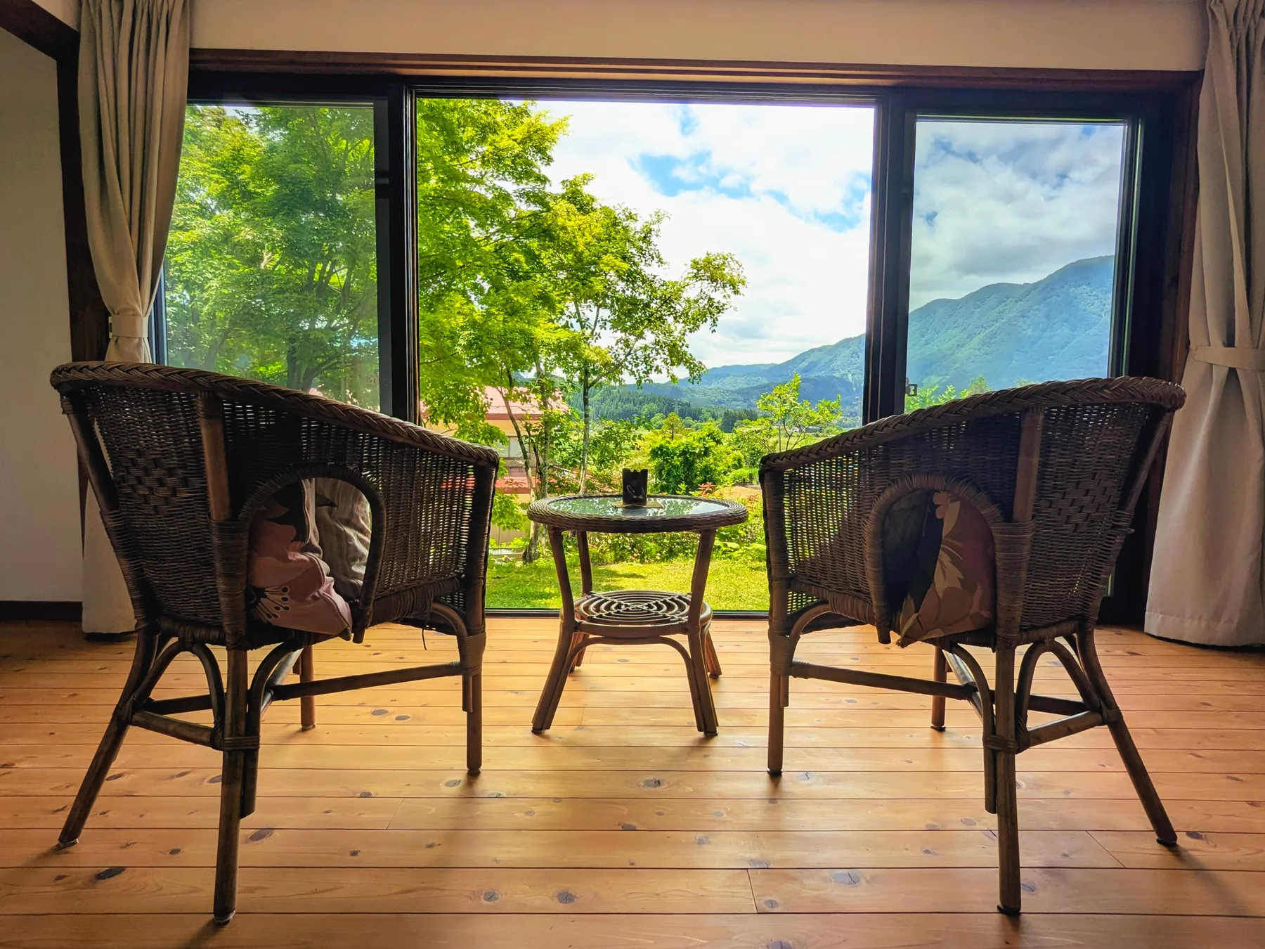 Sunroom seating at Rental Farmhouse Tamaki looking toward the garden and mountains