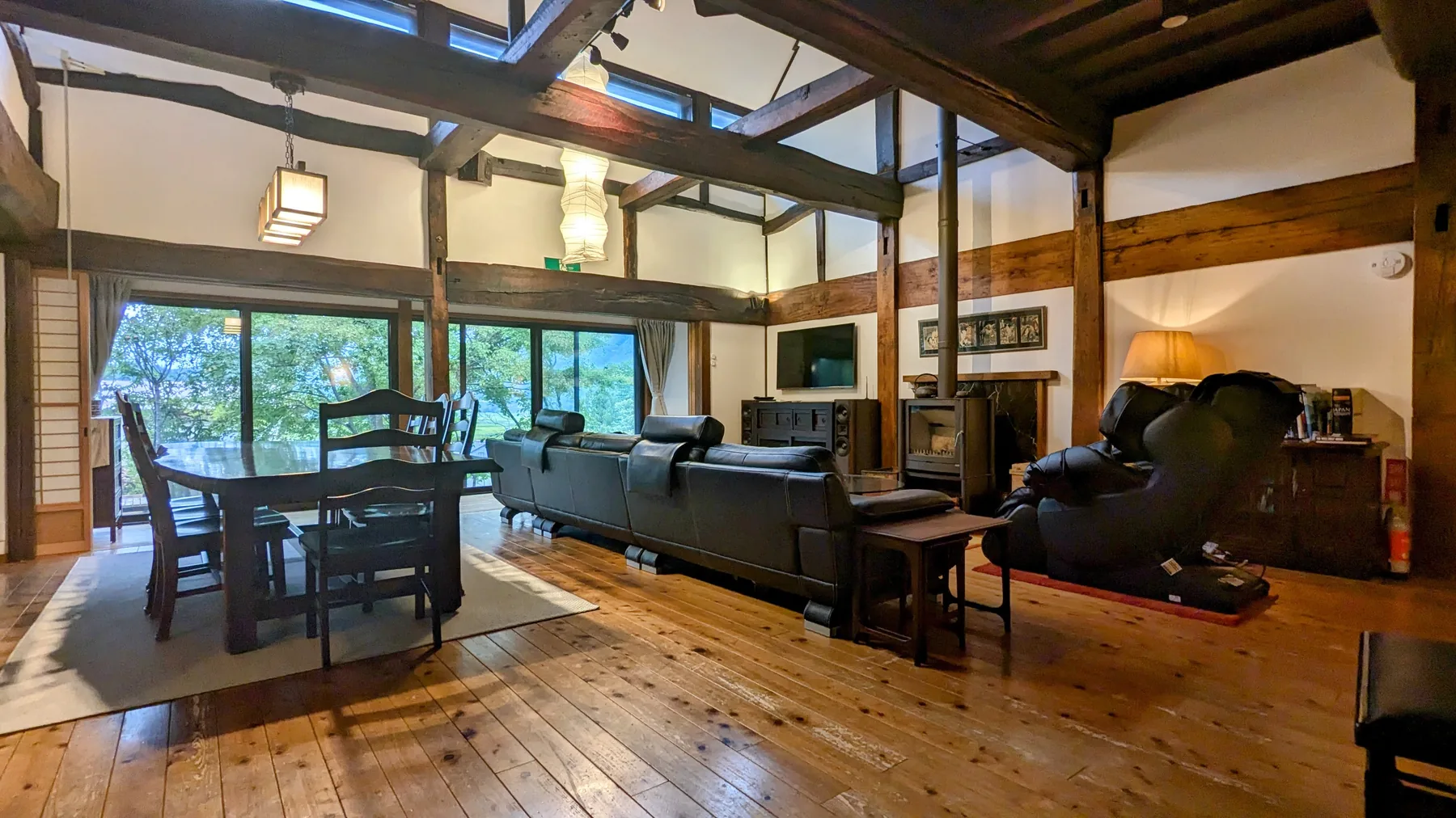 Wide open-plan living and dining space with original timber beams at Rental Farmhouse Tamaki in Hakuba