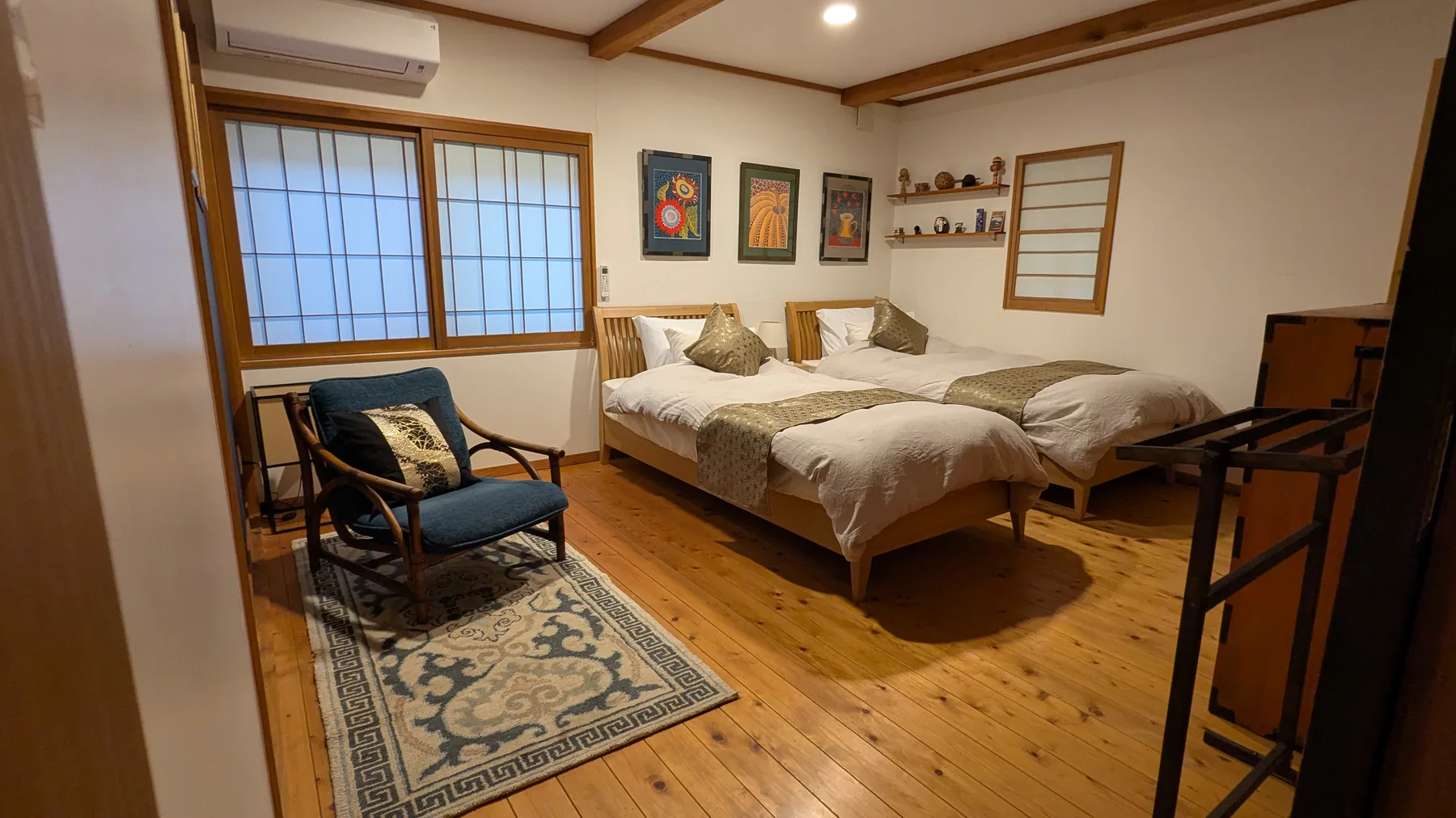 Twin bedroom with Japanese artwork and timber floor