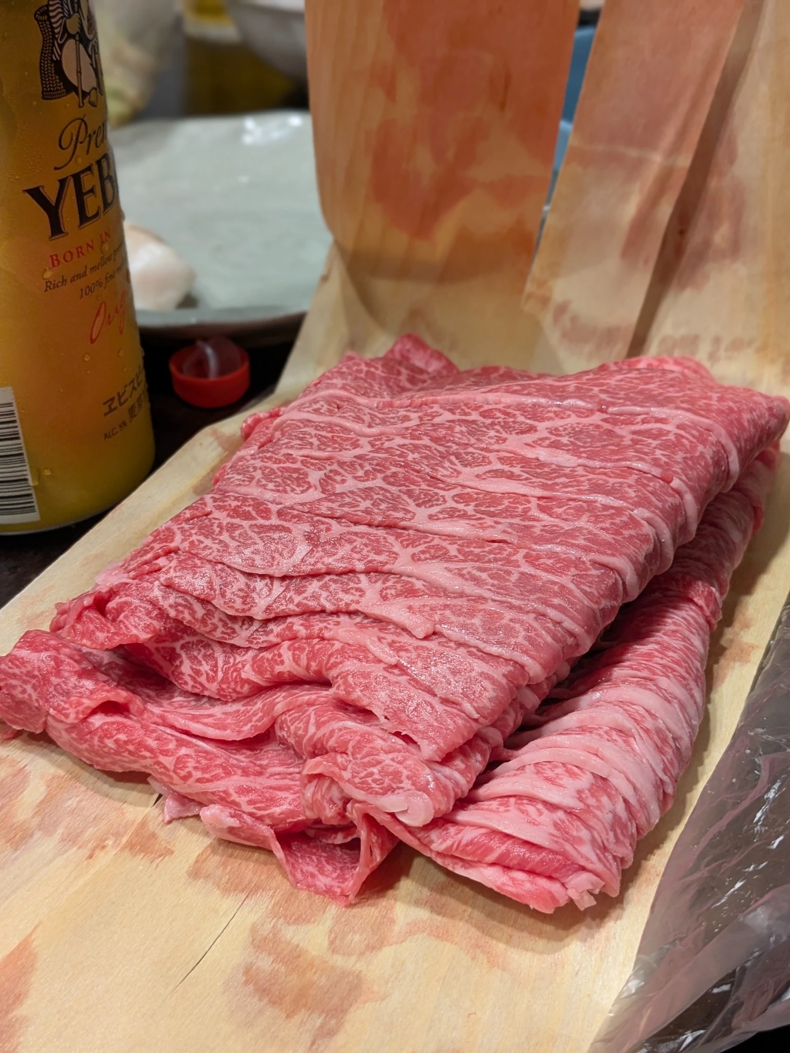 Thinly sliced marbled Japanese beef prepared for a winter hot pot meal